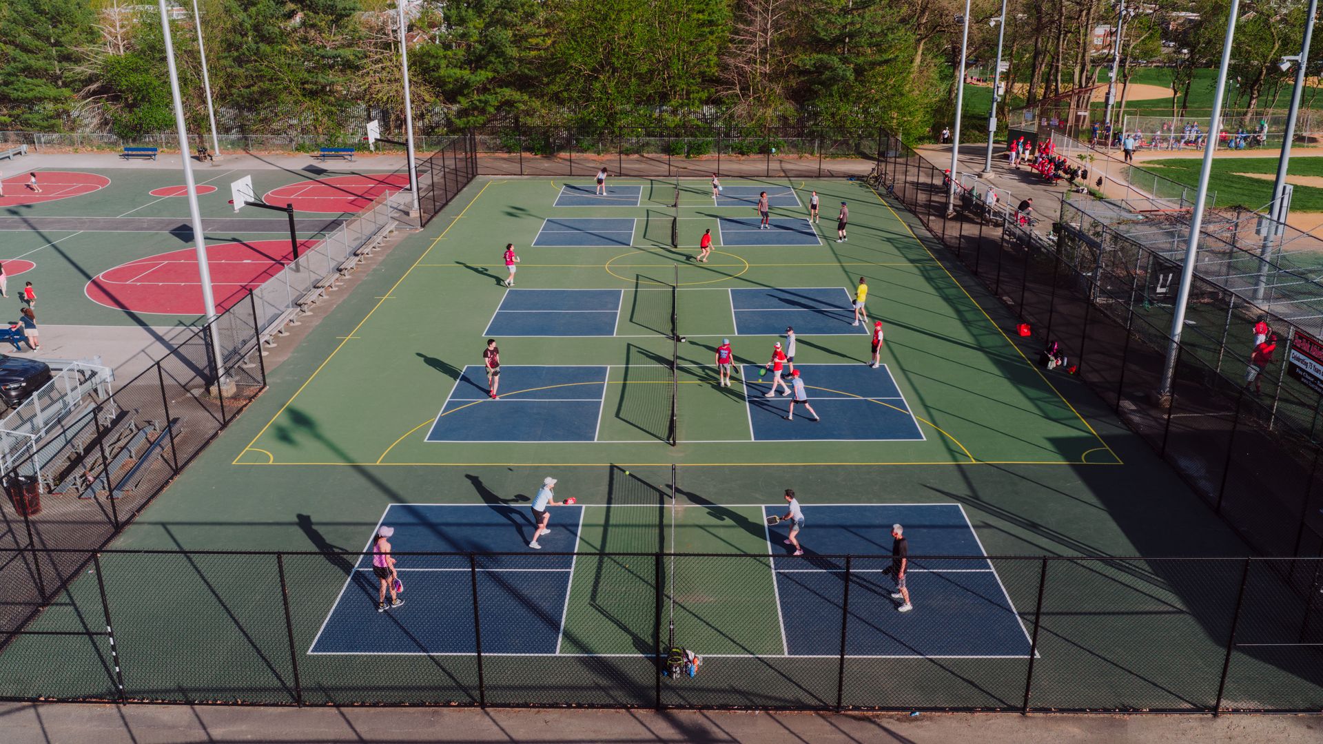 Aerial view of players on outdoor pickleball courts