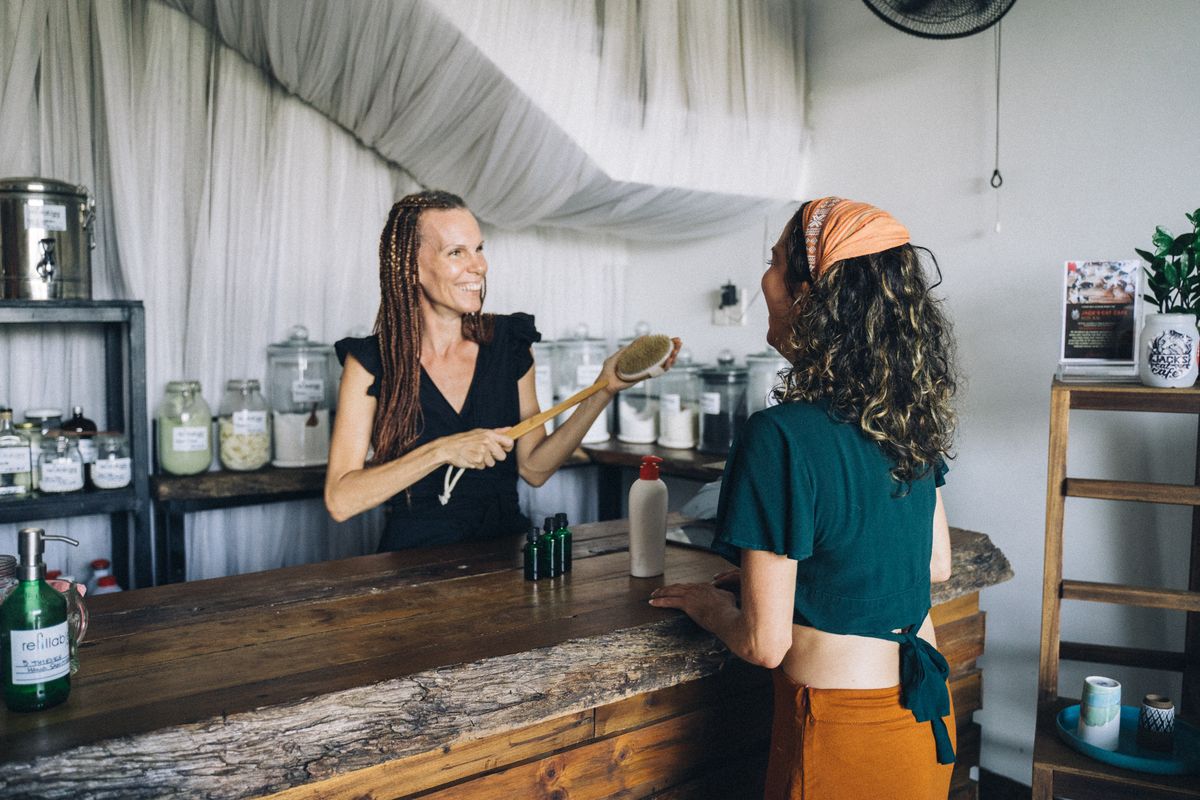 Retail shop owner helping a customer at the counter